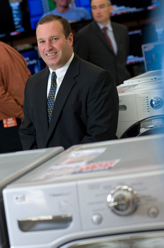 portrait of man in business suit inside electronics store